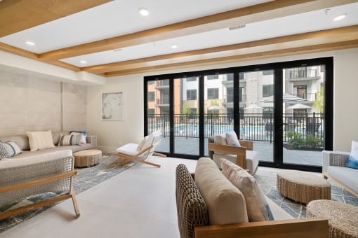a living room with couches and chairs and sliding glass doors