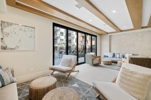 a living room with couches and chairs and a balcony