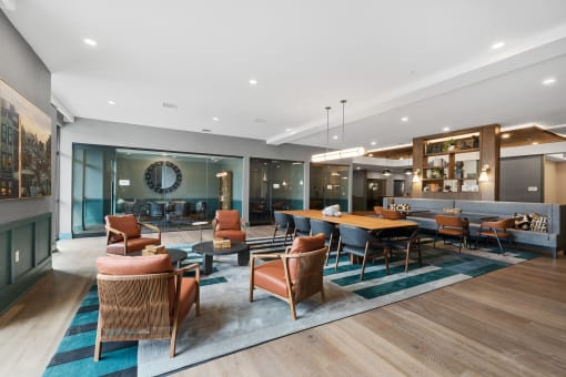 a lounge area with chairs and tables and a pool table