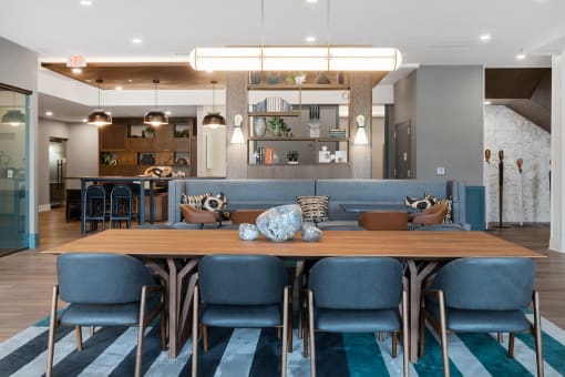 a dining room with blue chairs and a wooden table