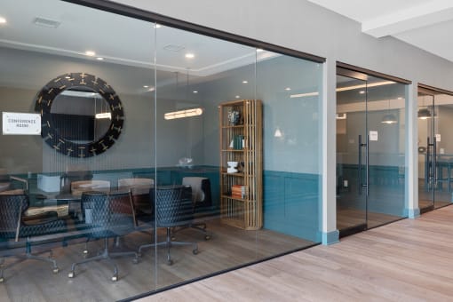a conference room with glass walls and a mirror