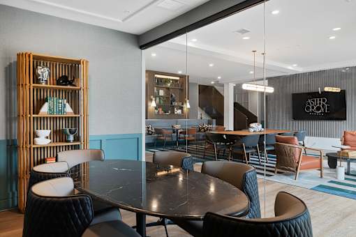 A modern dining area with a large table and chairs.