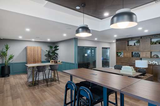 A modern dining room with a wooden table and chairs.