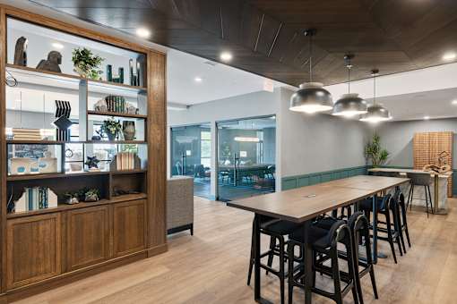 A modern dining area with a long table and chairs.