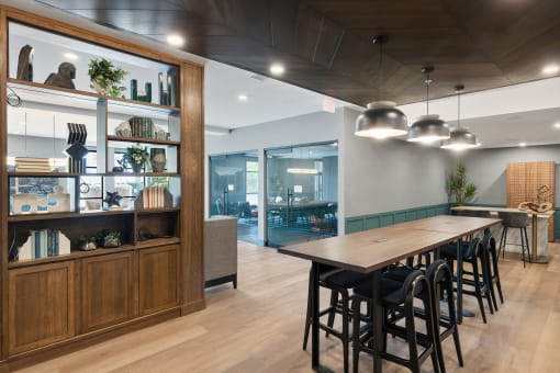 a dining room with a wooden table and chairs