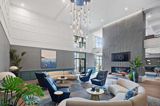 A modern living room with a fireplace and a large painting on the wall.