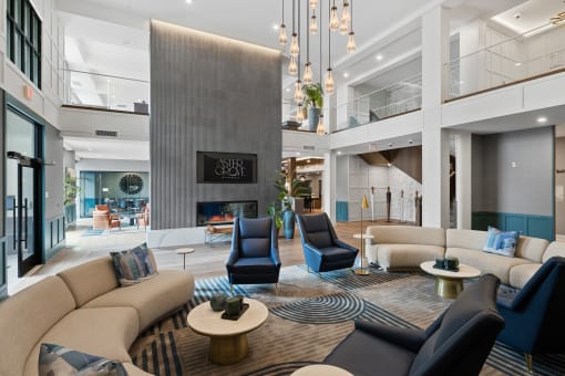 a living room with couches and chairs and a fireplace