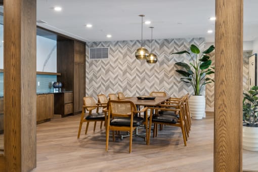 a dining room with a wooden table and chairs