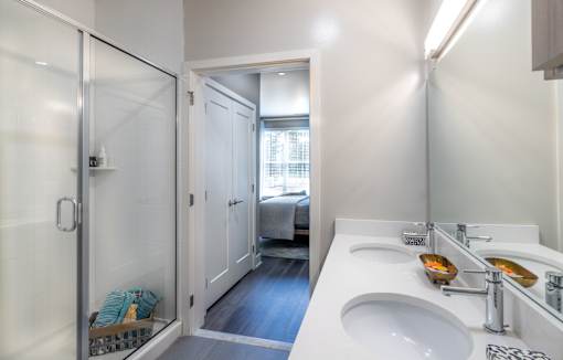 Modern bathroom with dual vanity and glass shower at Inwood at Renaissance Square Apartments, Marlton, New Jersey