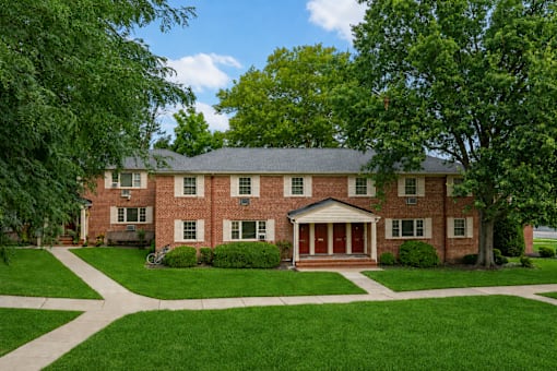 A large red brick house with a white front door.