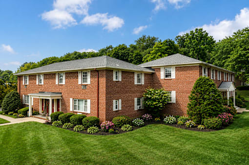 A large red brick house with a white door and windows.