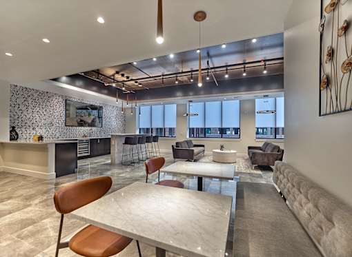 A modern living room with a fireplace and a dining table.