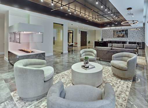 a living room with couches and chairs and a table