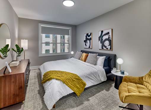 bedroom with white bedspread and pillows and a yellow blanket