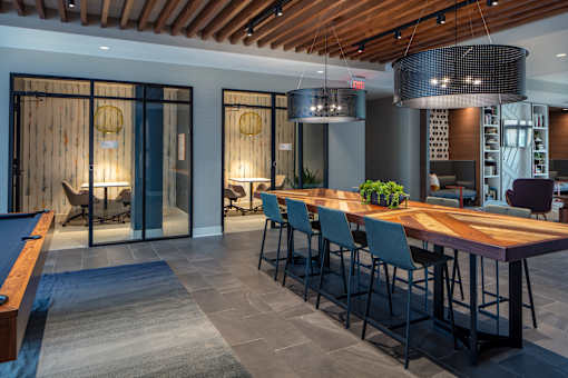 Community workspace with communal table and conference rooms at Inwood at Renaissance Square Apartments, Marlton, NJ