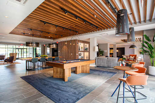 Community lounge with billiards table and wood beam ceiling at Inwood at Renaissance Square Apartments, Marlton, New Jersey