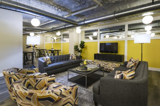 a living room with couches and chairs and a television