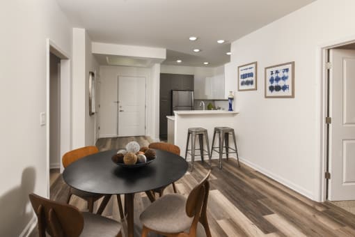 a kitchen and dining room with a table and chairs