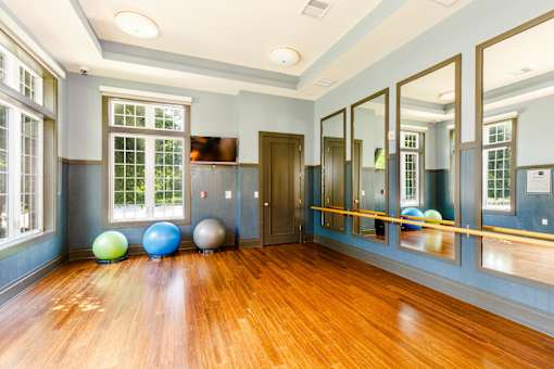 Fitness studio with mirrored wall and polished hardwood flooring at Highlands at Hilltop Apartments, Verona, 07044