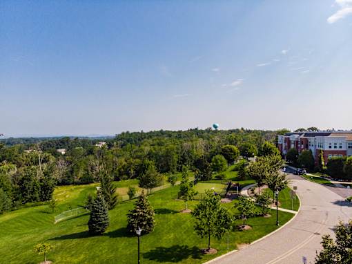 Aerial view of landscaped grounds and tree lined property at Highlands at Hilltop Apartments, New Jersey