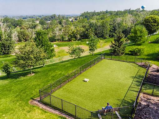 Fenced dog park with artificial turf and open lawn at Highlands at Hilltop Apartments, New Jersey, 07044