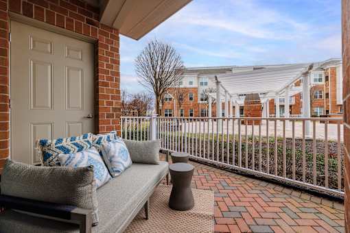 Private patio with seating and brick pavers at Highlands at Hilltop Apartments, Verona