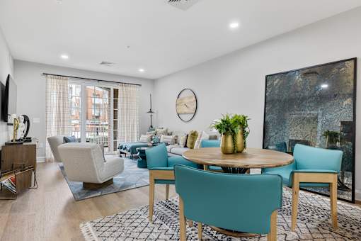 Open concept living and dining room with turquoise chairs at Highlands at Hilltop Apartments, Verona, NJ