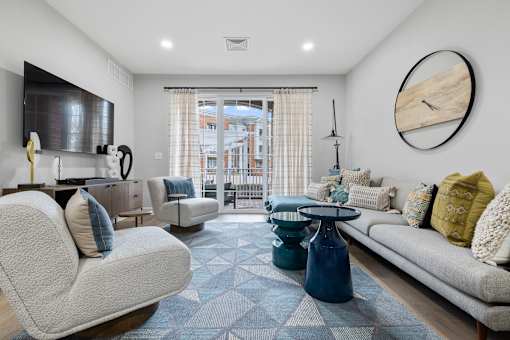 Living room with gray sofas and blue area rug at Highlands at Hilltop Apartments, Verona, 07044