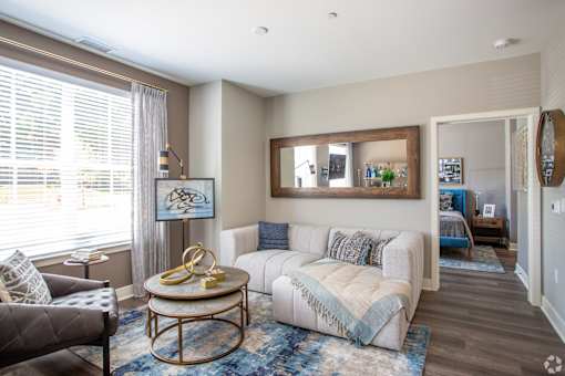 Living room with large mirror and view into bedroom at Inwood at Renaissance Square Apartments, Marlton, NJ 08053