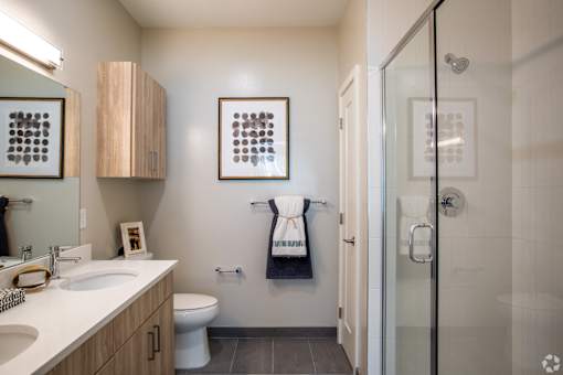 Bathroom with wood vanity and walk-in shower at Inwood at Renaissance Square Apartments, Marlton, NJ