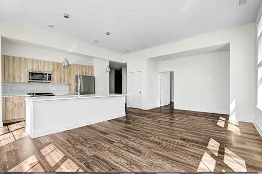 Open layout living and kitchen area with wood flooring at Inwood at Renaissance Square Apartments, Marlton