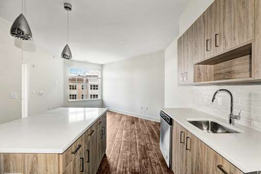 Galley kitchen with island and white countertops at Inwood at Renaissance Square Apartments, Marlton, NJ