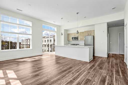Open concept living area with kitchen island and large windows at Inwood at Renaissance Square Apartments, New Jersey, 08053