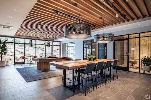 Community lounge with billiards and communal dining table at Inwood at Renaissance Square Apartments, Marlton