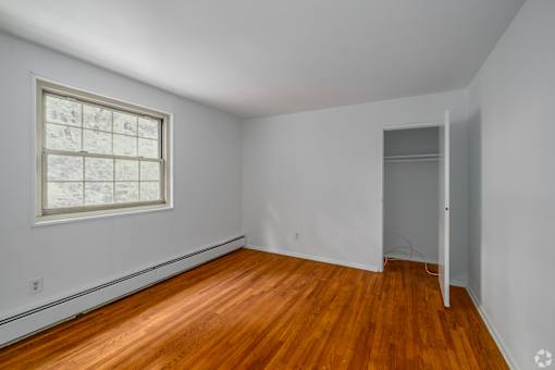 A room with a wooden floor and a window.