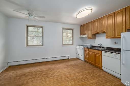 A kitchen with wooden cabinets and a white refrigerator.