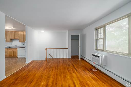 A room with wooden floors and white walls.