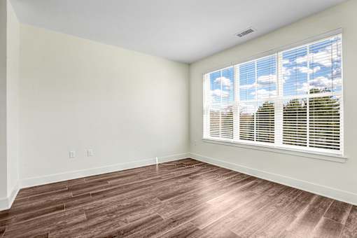 Empty bedroom with large window and wood flooring at Inwood at Renaissance Square Apartments, New Jersey, 08053