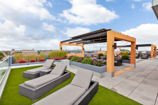 a roof deck with couches and a pergola