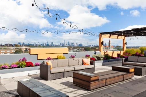 a rooftop patio with a view of the philadelphia skyline