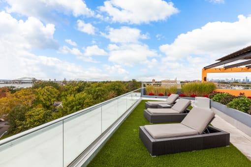 a roof deck with couches and a grassy area