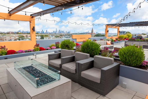 a seating area on the rooftop of a building with a view of the philadelphia skyline