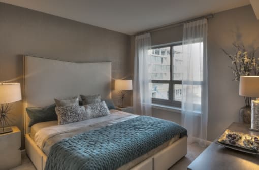 Modern bedroom with city views at RiverParc Apartments, Weehawken