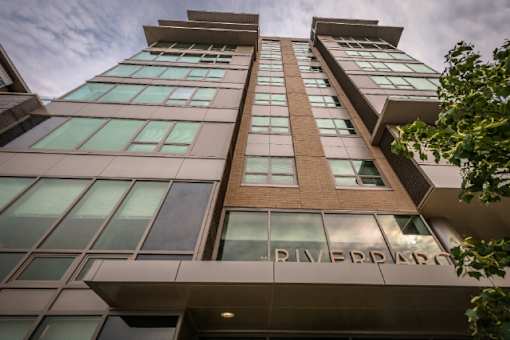Exterior building facade with large windows at RiverParc Apartments, Weehawken, NJ 07086