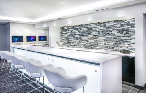 Modern community lounge with bar seating at RiverParc Apartments, Weehawken, New Jersey