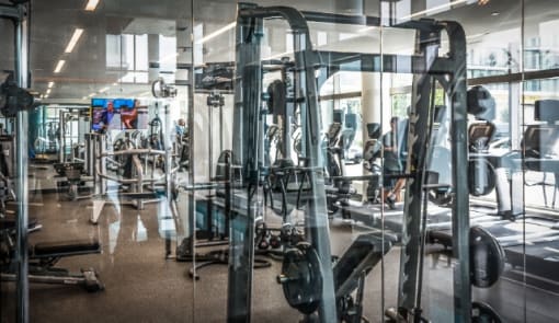 Fitness center with strength training equipment at RiverParc Apartments, New Jersey