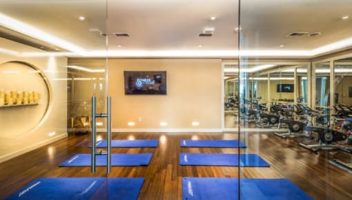 Fitness center with yoga studio and equipment at RiverParc Apartments, New Jersey, 07086