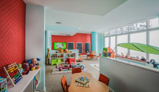 Bright childrens playroom with colorful furniture and toys at RiverParc Apartments, Weehawken
