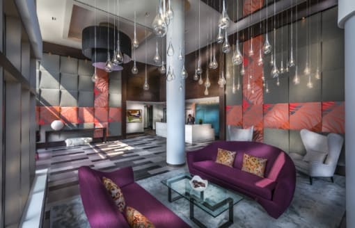 Modern lobby with pendant lighting and purple sofas at RiverParc Apartments, Weehawken, New Jersey