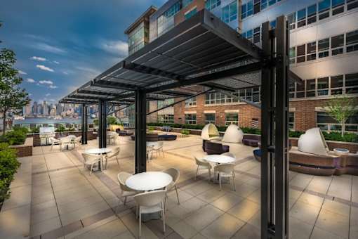 Rooftop terrace with seating and skyline views at RiverParc Apartments, Weehawken, NJ